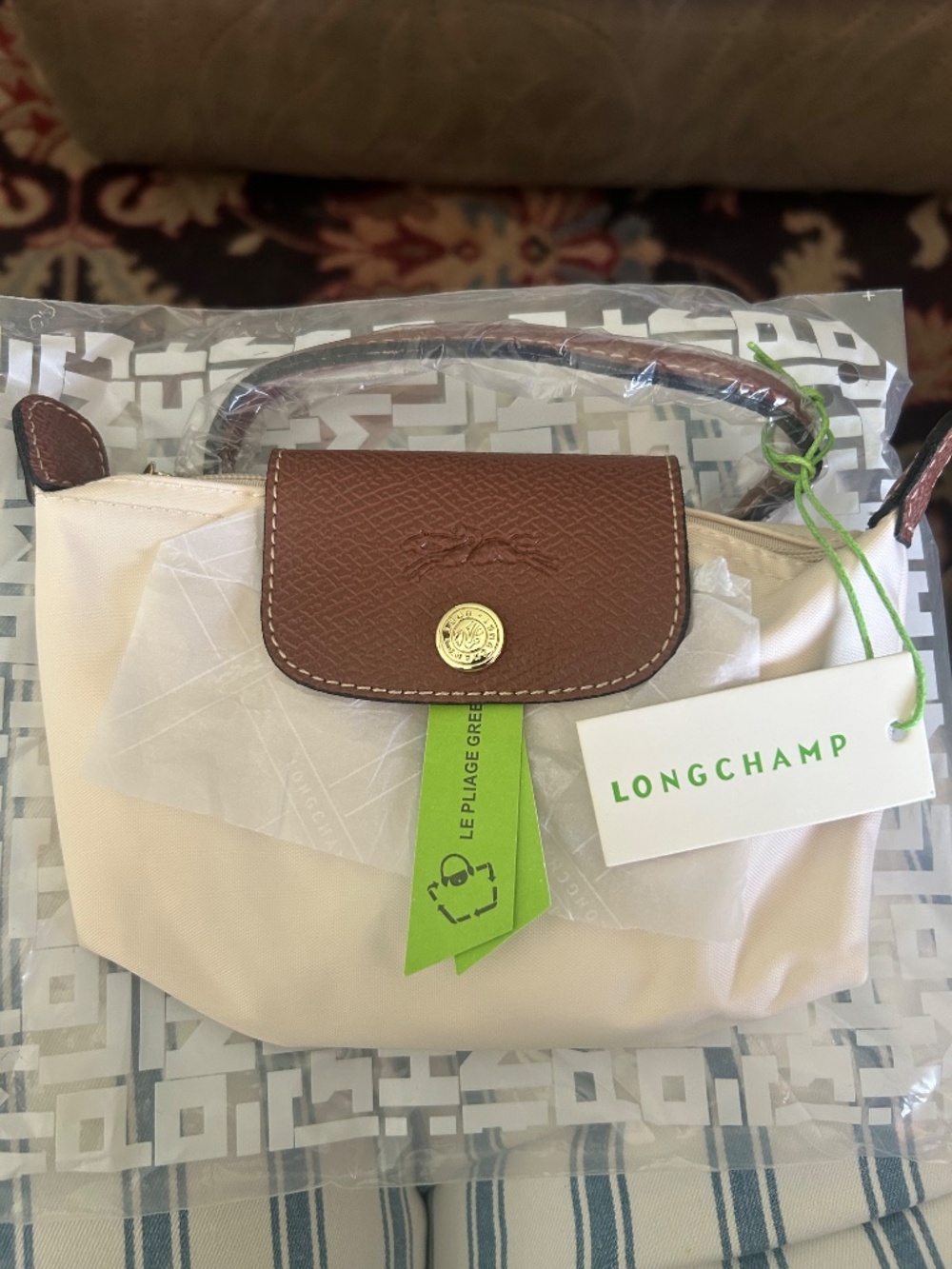 Compact cream nylon mini tote. Brown leather flap and top handle. Gold-tone butt - Picture 4 of 5